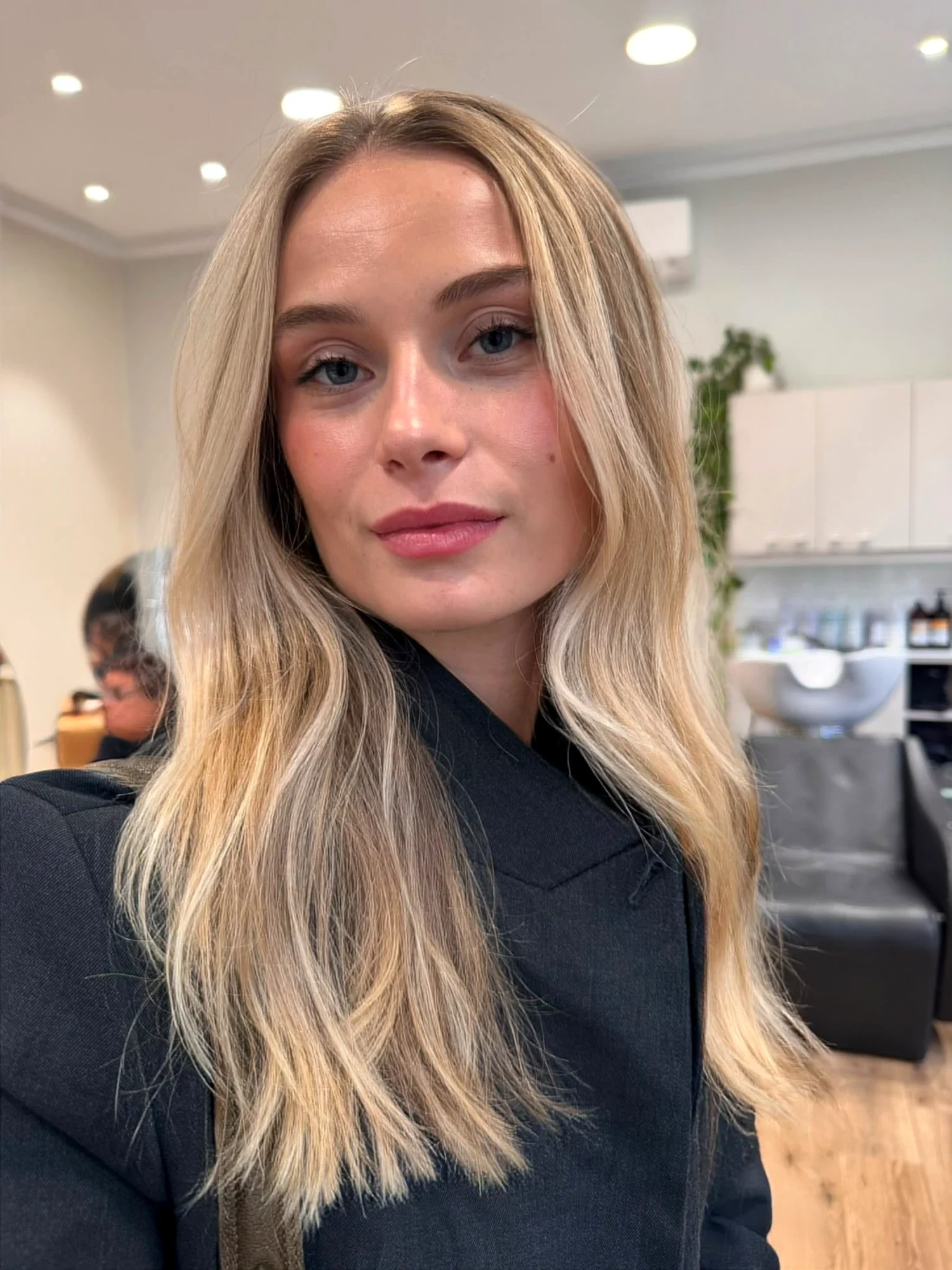Balayage blond froid lumineux sur brushing lisse, réalisé au salon Le 83 à Nancy